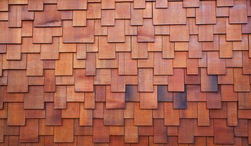A close up of red simulated wood shake shingles.